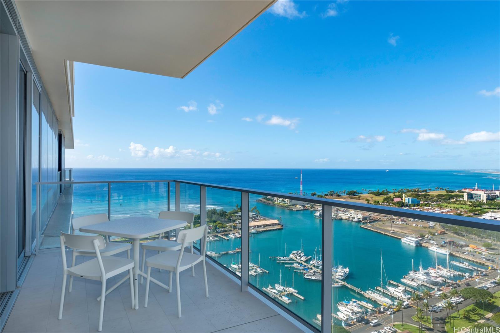 a balcony with furniture and a floor to ceiling window