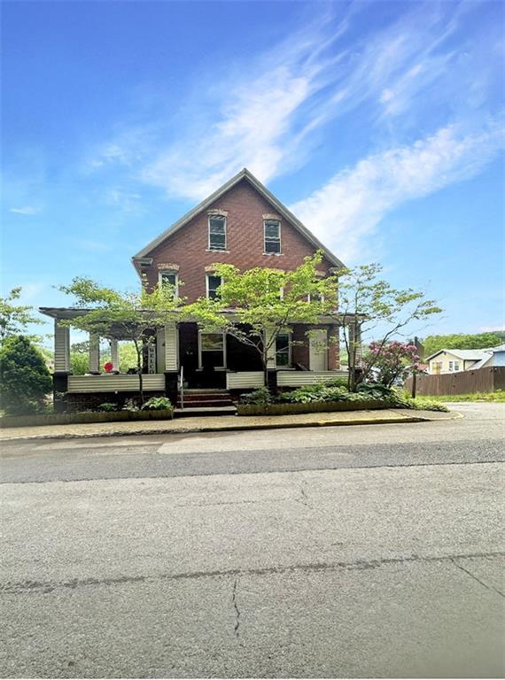 a view of a house next to a yard and many windows