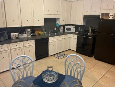 a kitchen with stainless steel appliances granite countertop a stove a sink dishwasher and white cabinets