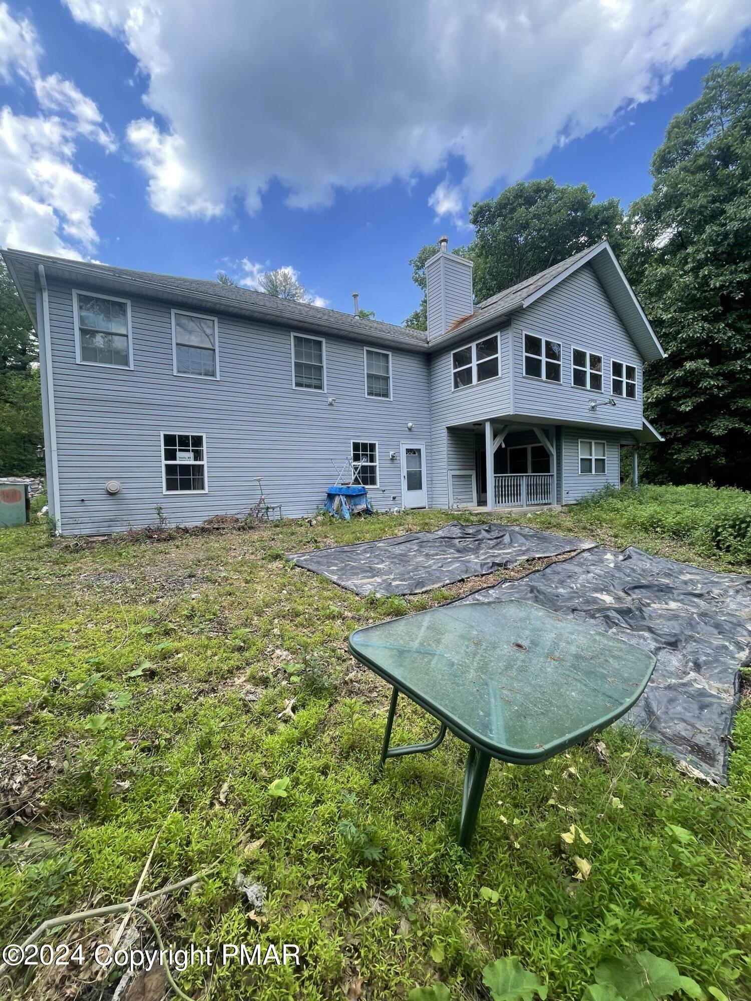 a view of a house with table and chairs