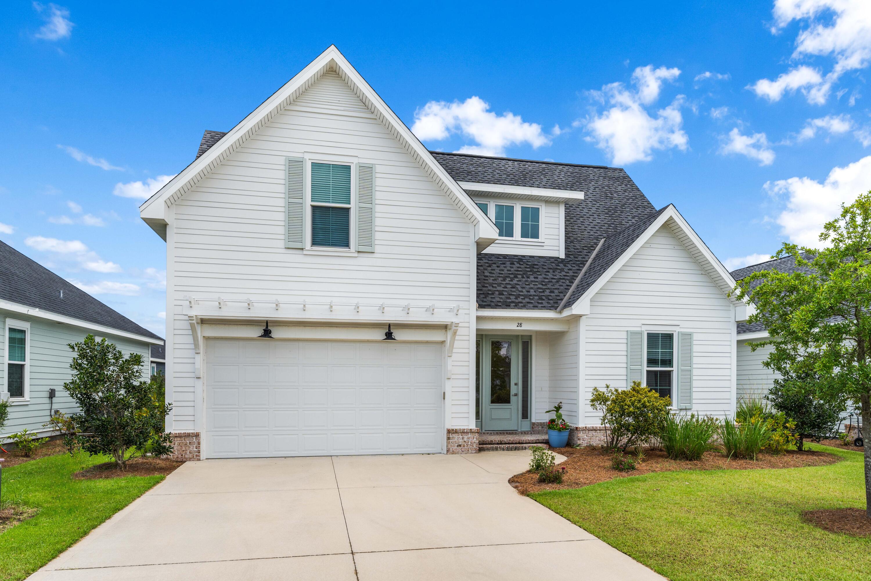 a front view of house with yard and green space