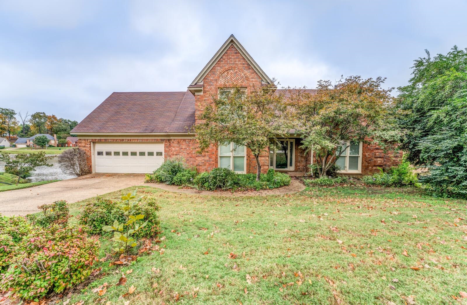 a view of a house with a yard and garage