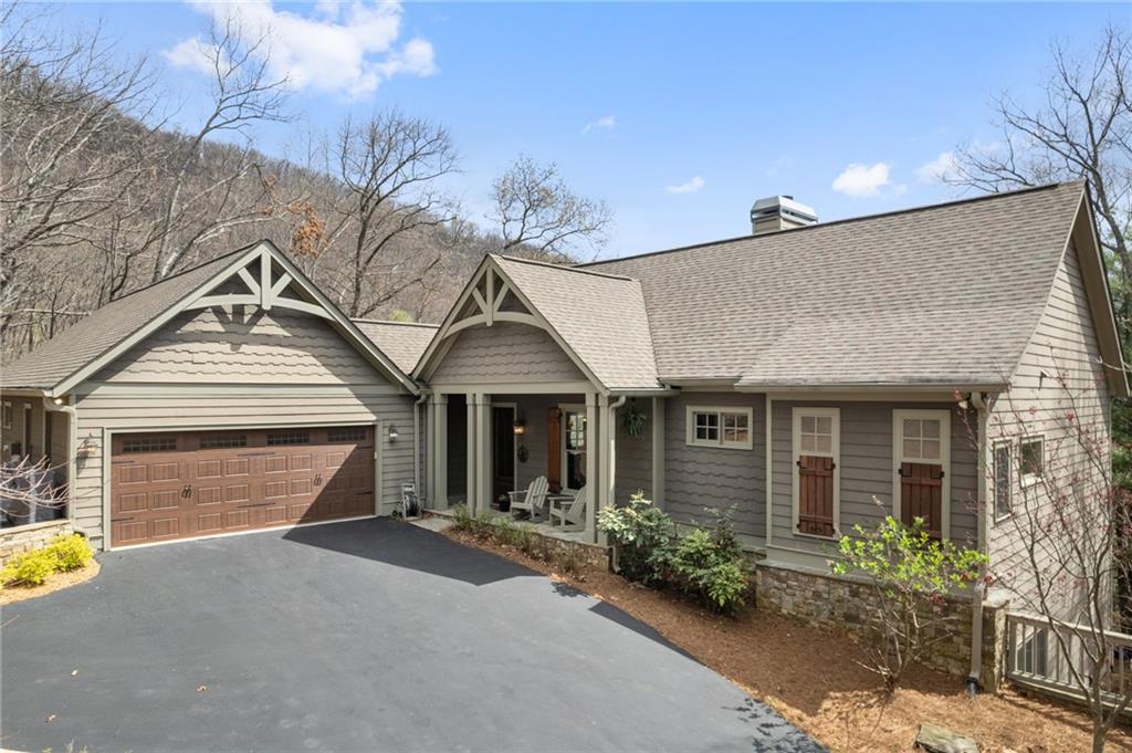 a front view of a house with a garden and outdoor seating