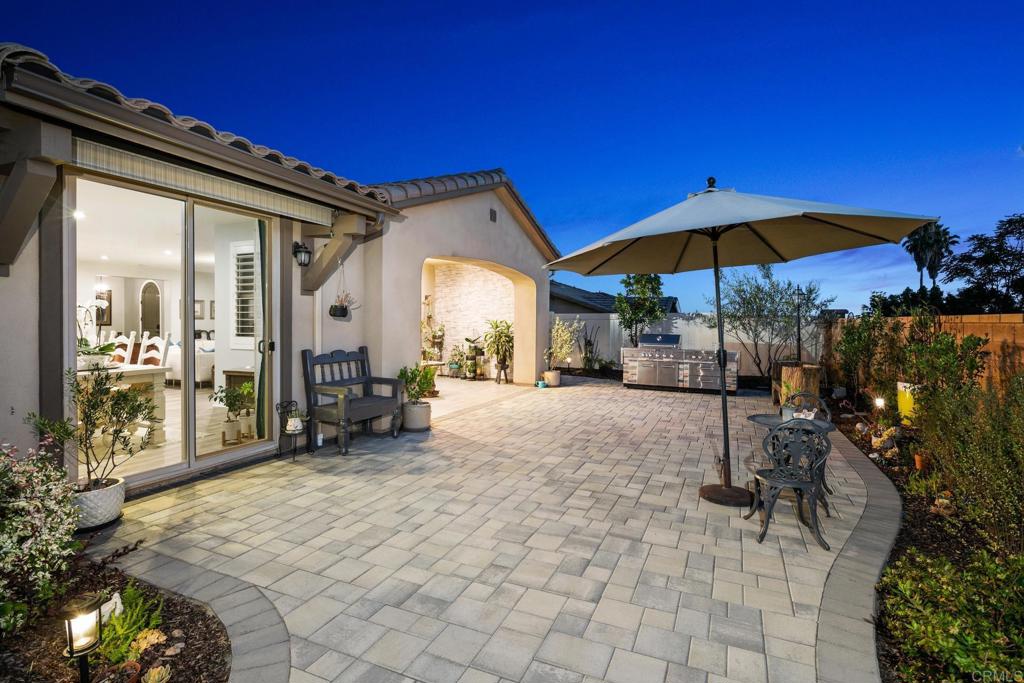 a view of a house with backyard and sitting area