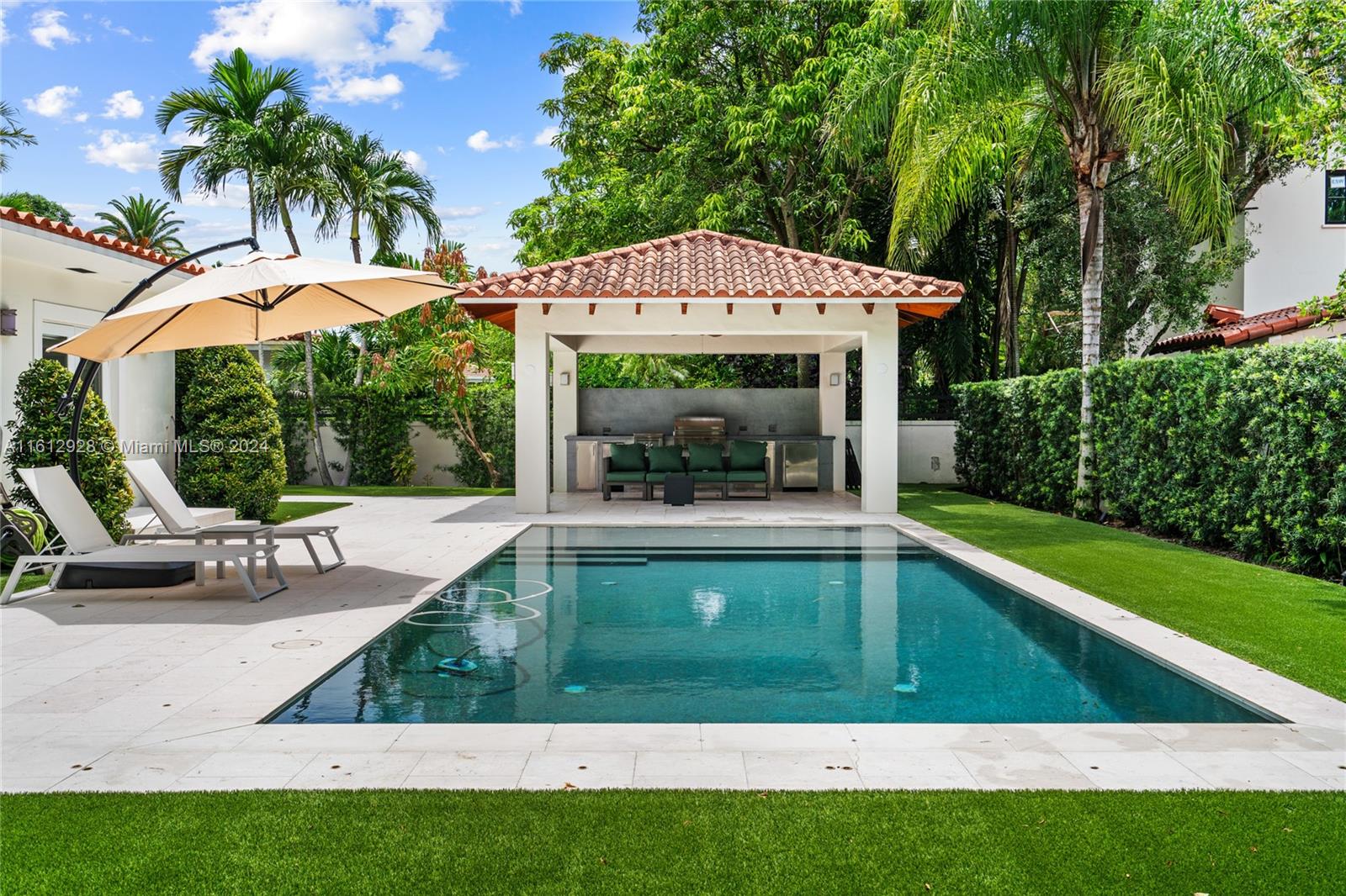 a view of a house with backyard porch and sitting area