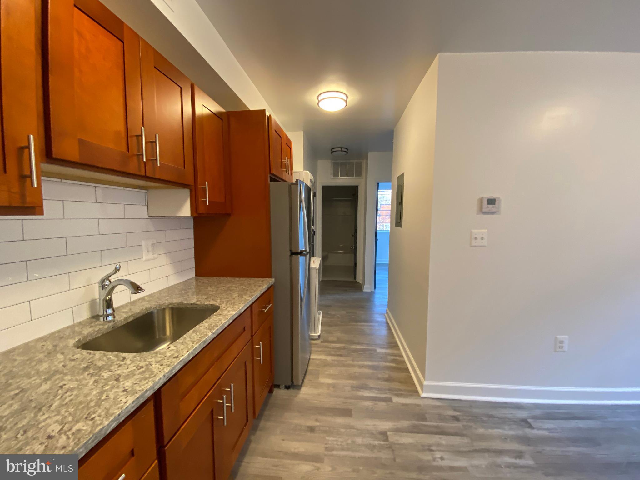 a kitchen with sink cabinets and refrigerator