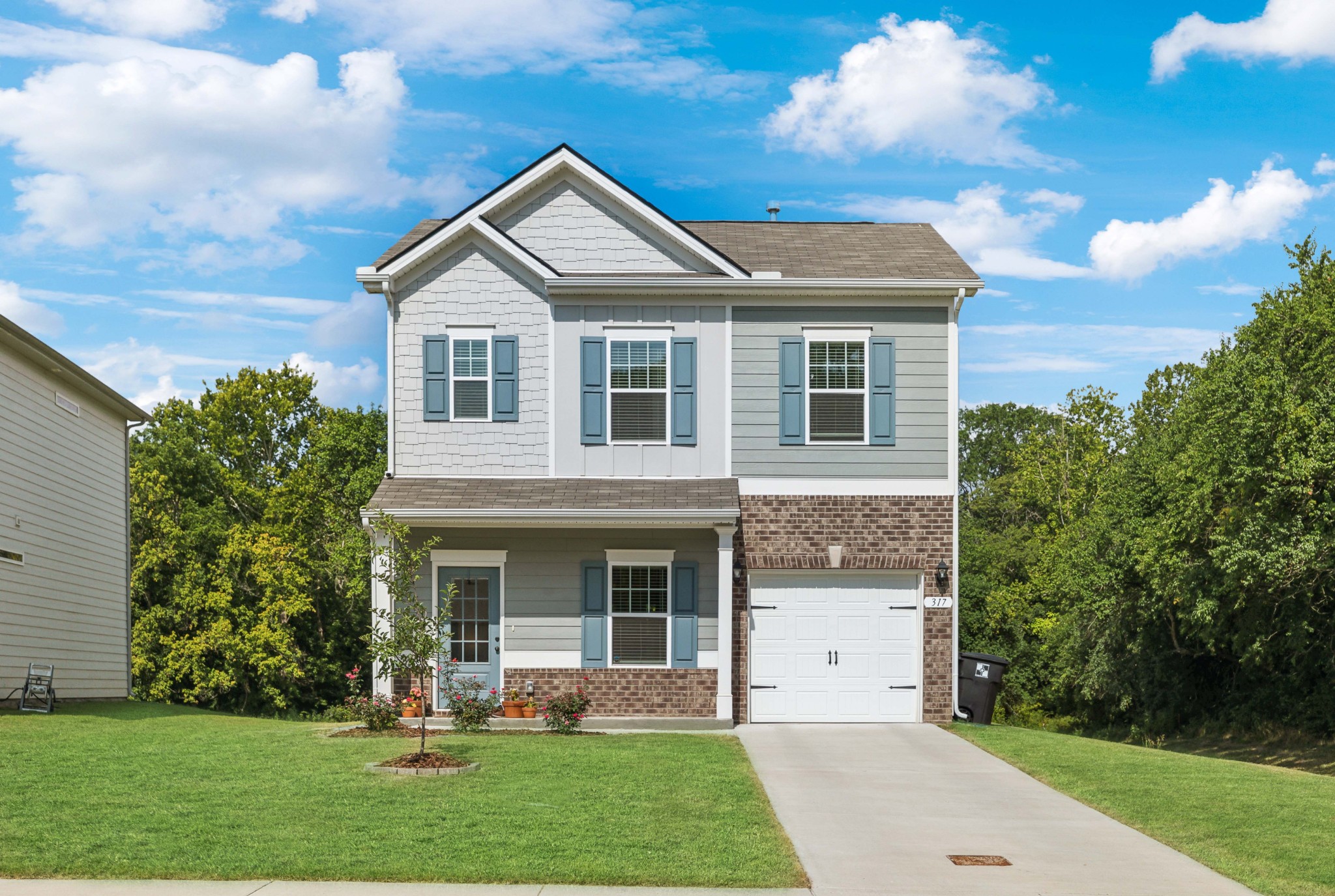 a front view of a house with a yard