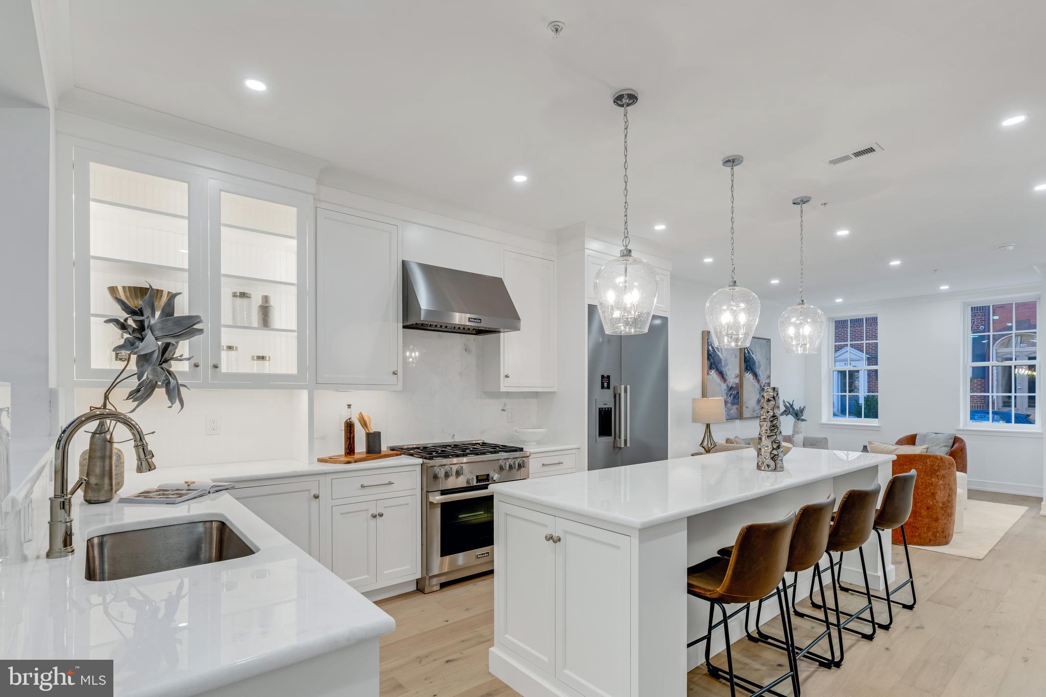 a kitchen with a sink a stove a dining table and chairs