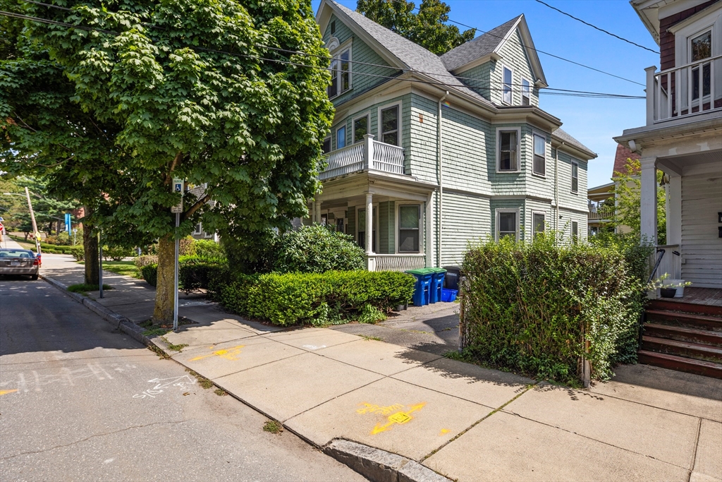 a front view of a house with a garden