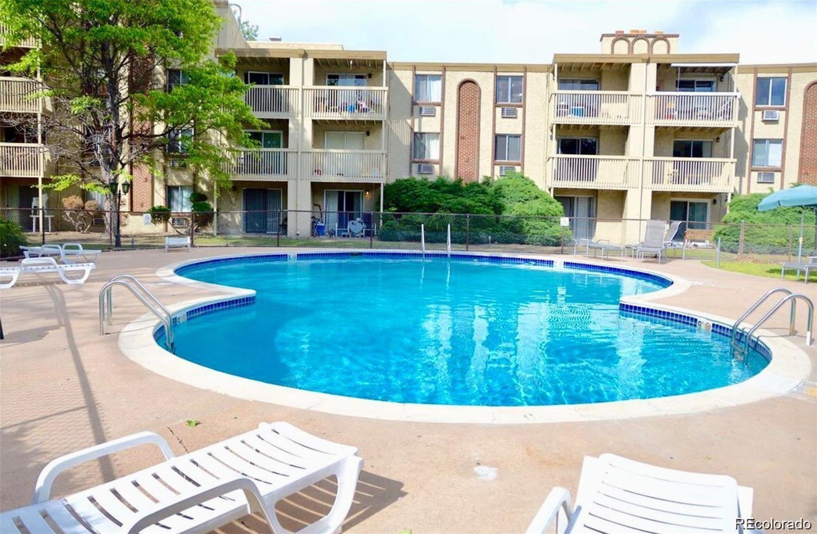 a view of a house with swimming pool and sitting area