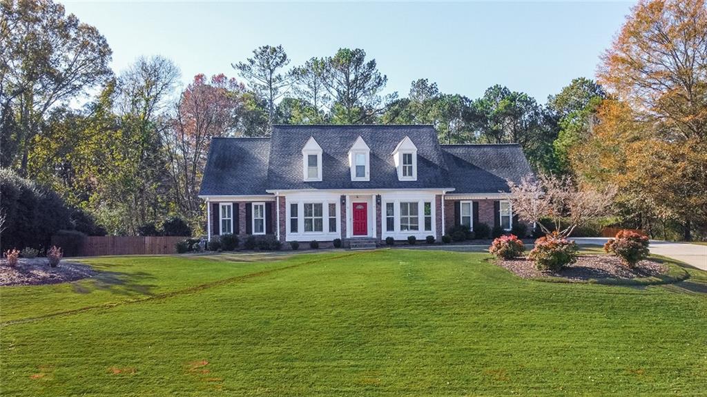 a view of a house with a yard porch and sitting area