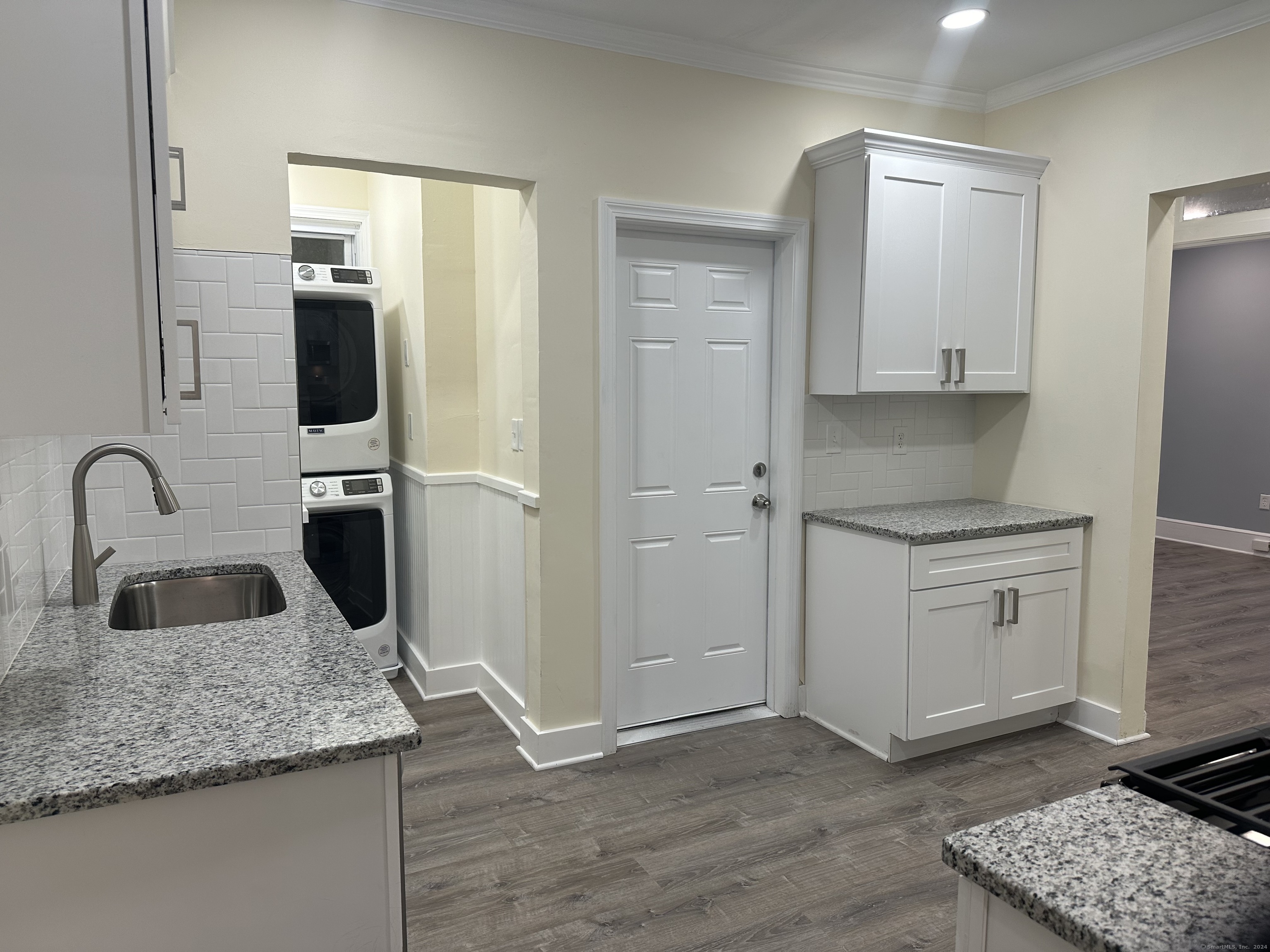 a kitchen with a sink and a refrigerator