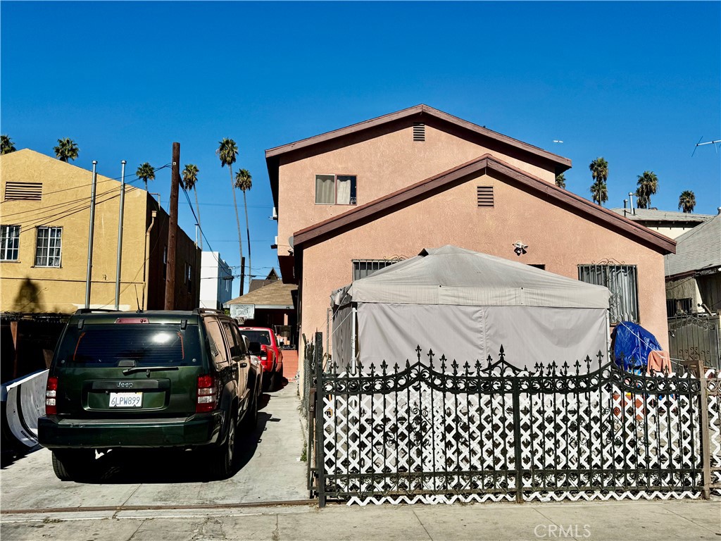 a front view of a house with a car parked