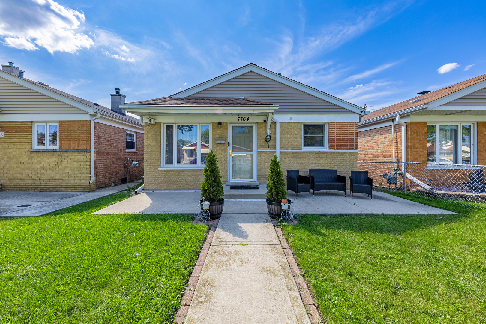 a front view of house with yard and outdoor seating