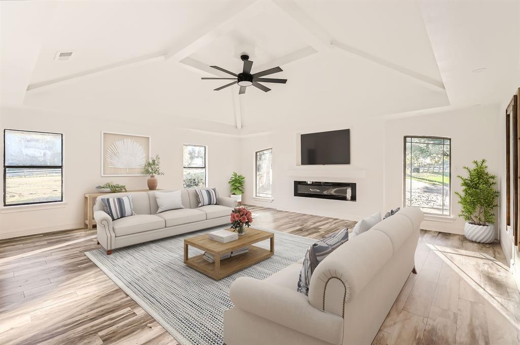 a living room with furniture a flat screen tv and a large window