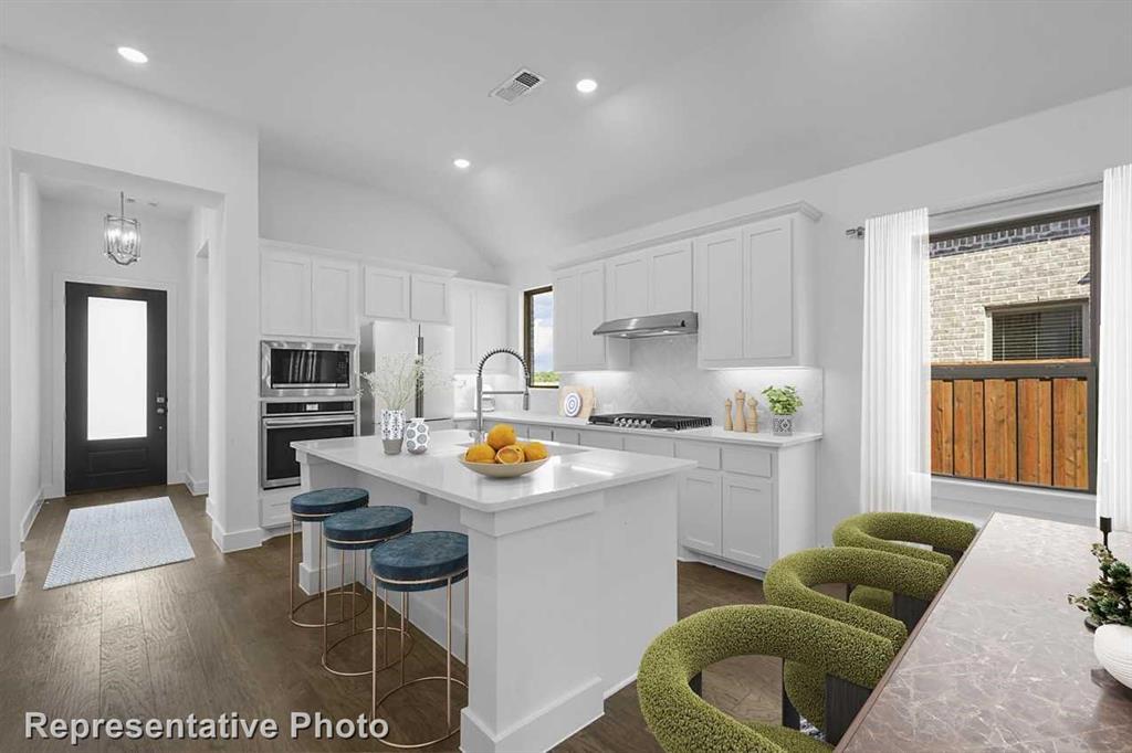 a kitchen with stainless steel appliances granite countertop a sink and cabinets