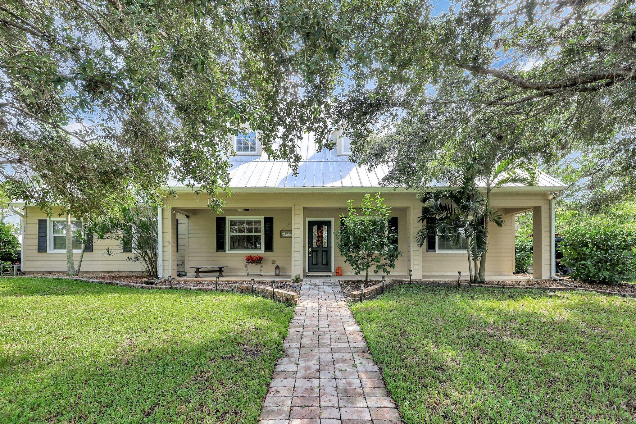 a front view of house with yard and green space