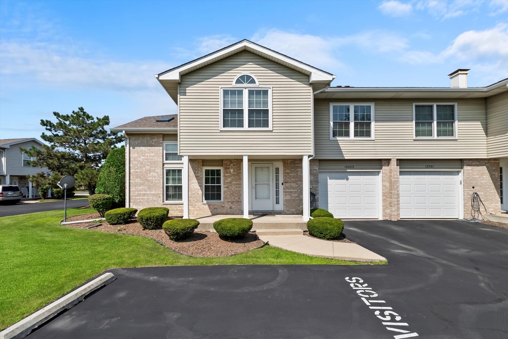 a front view of a house with a yard and garage