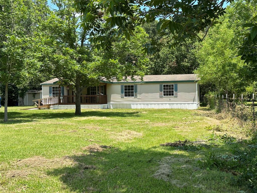 a front view of house with yard and swimming pool