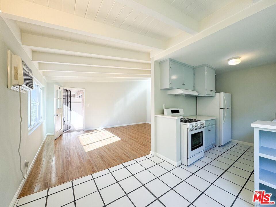 a kitchen with a stove a sink and a refrigerator