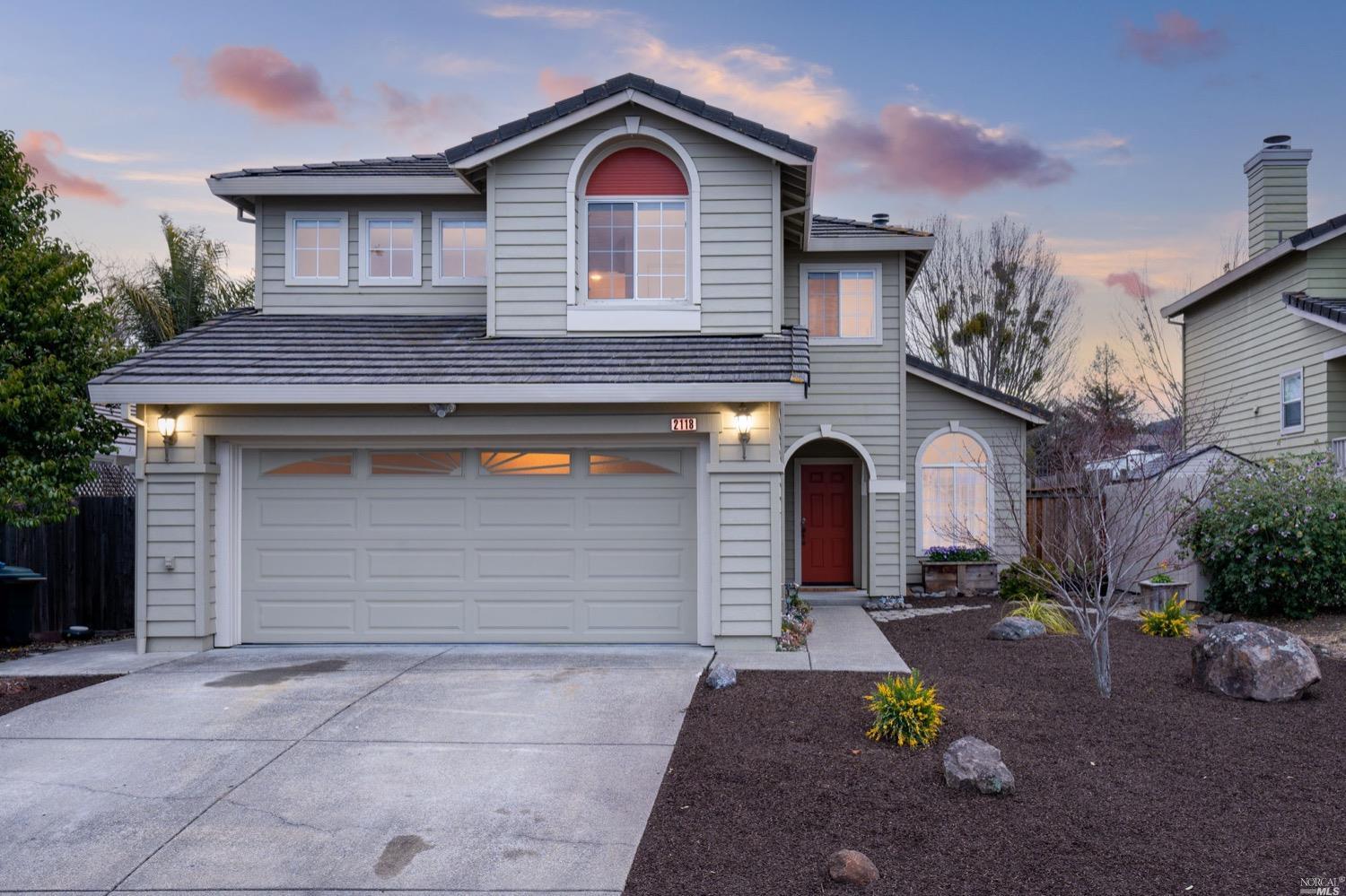 a front view of a house with a yard and garage