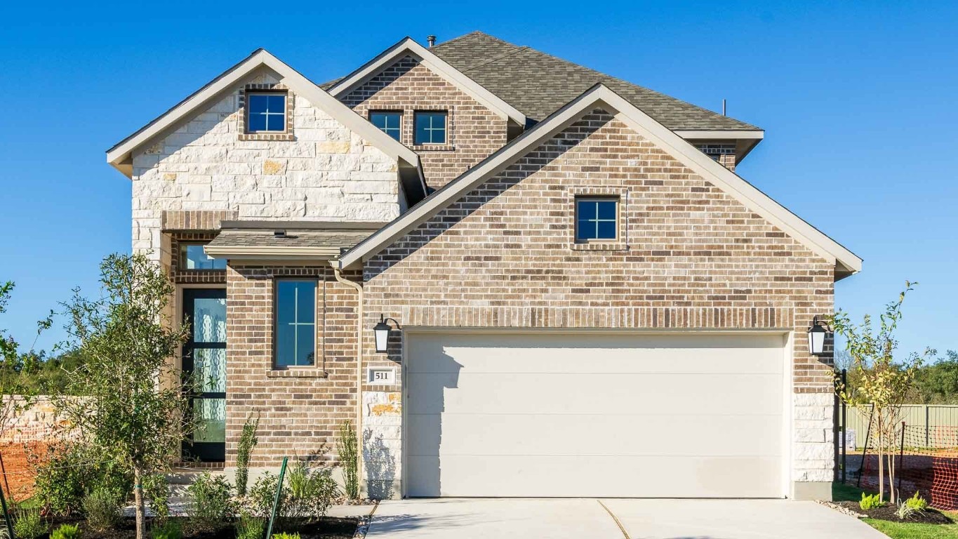 a front view of a house with a yard