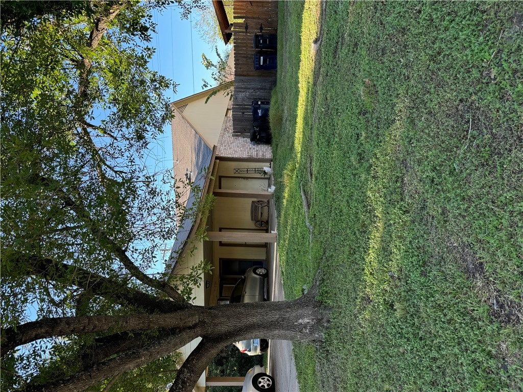 a view of house with a yard