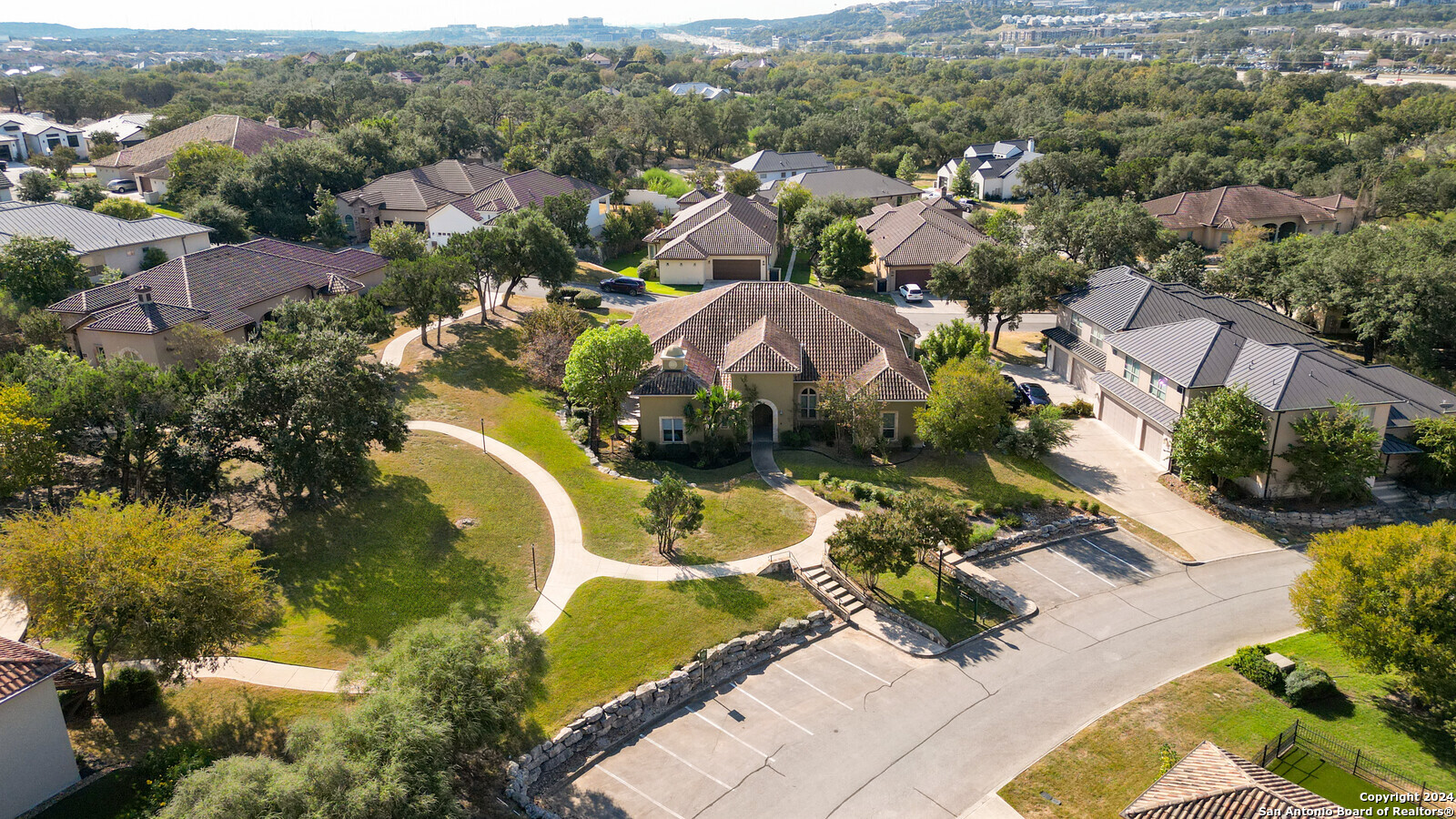 an aerial view of residential houses with outdoor space and swimming pool