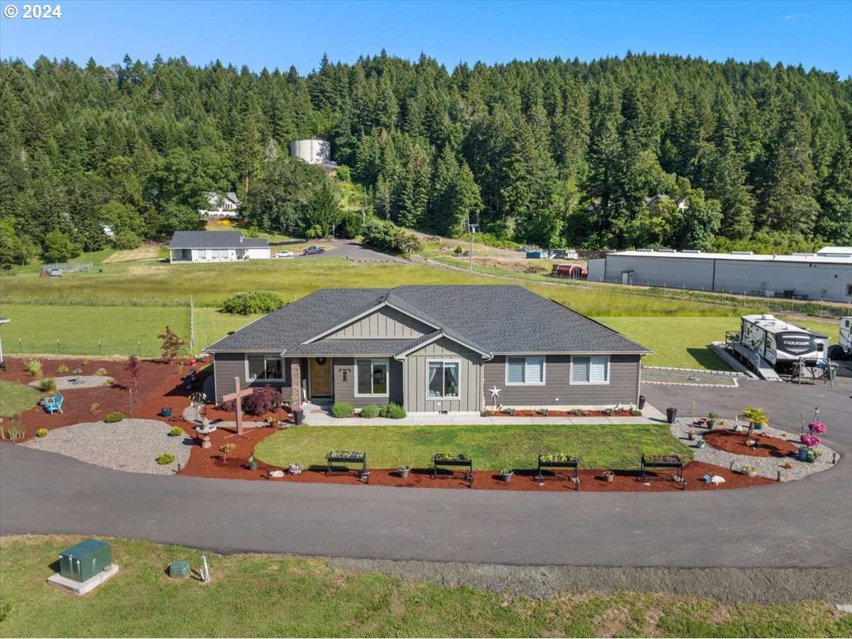 an aerial view of a house with swimming pool patio and lake view