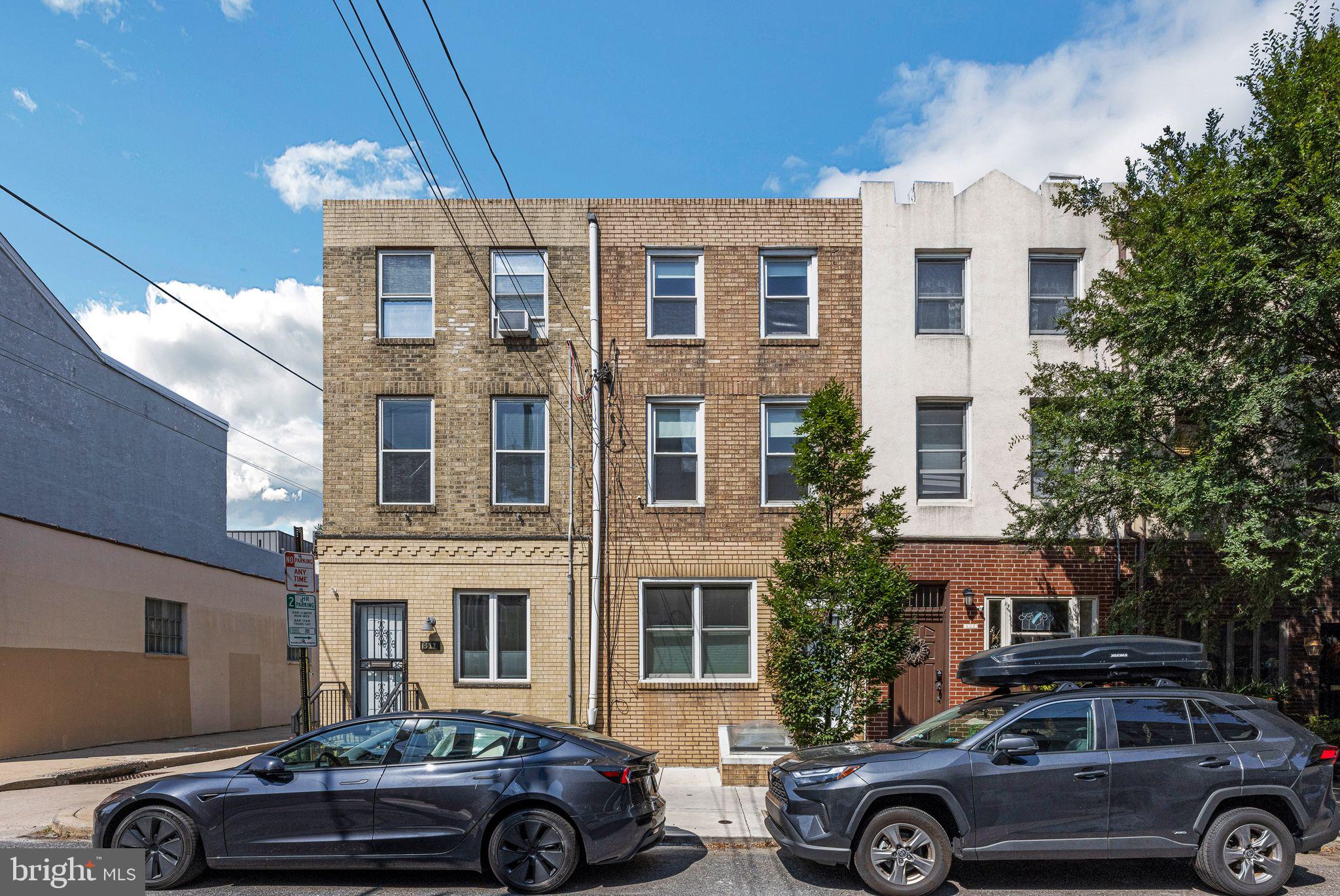 a front view of a house with parking space