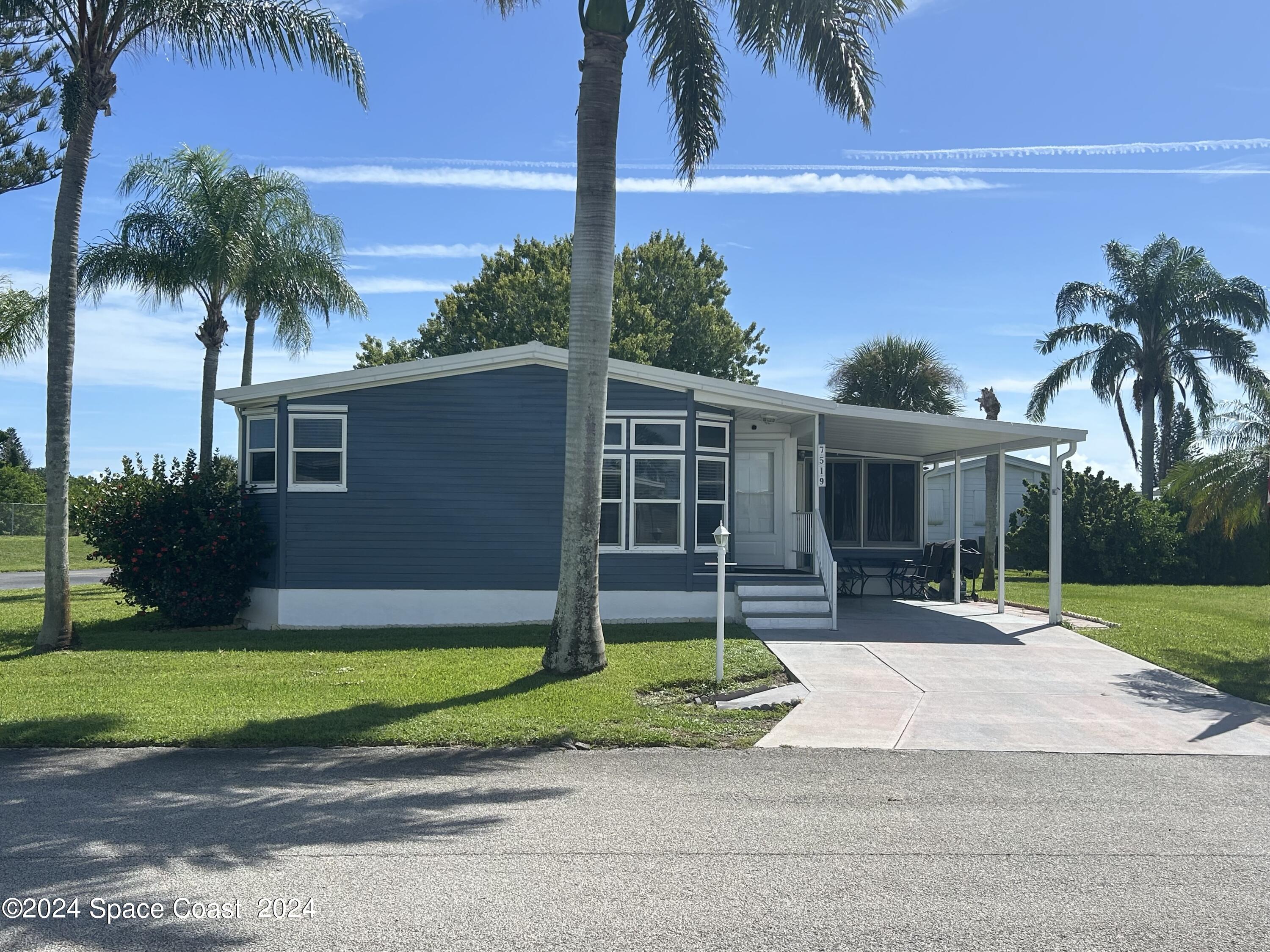 a house with palm tree in front of it