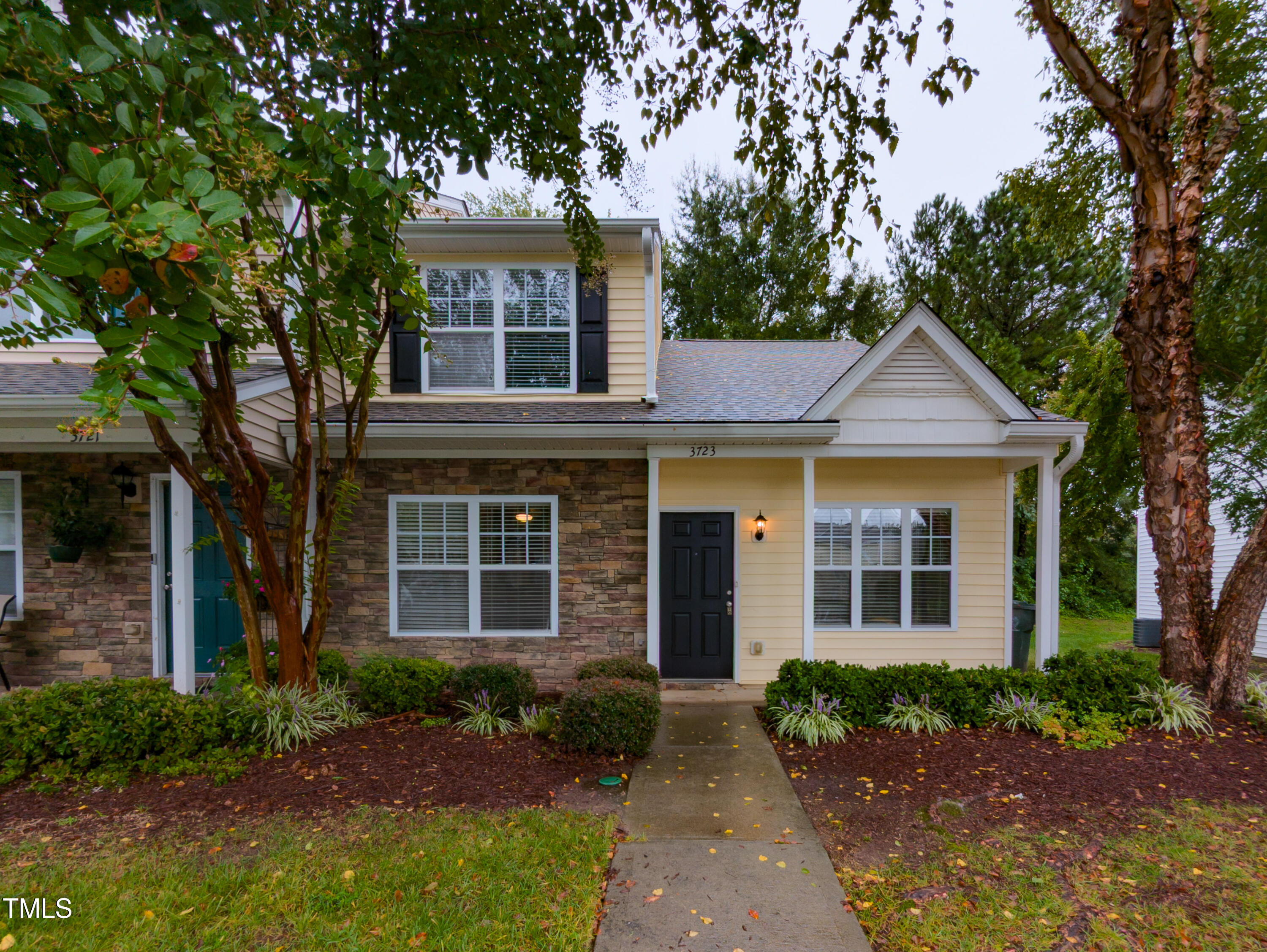 a front view of a house with garden