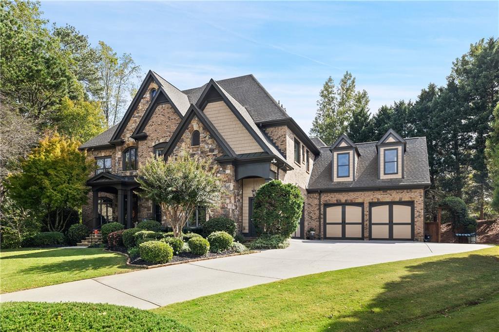 a front view of a house with a yard and garage