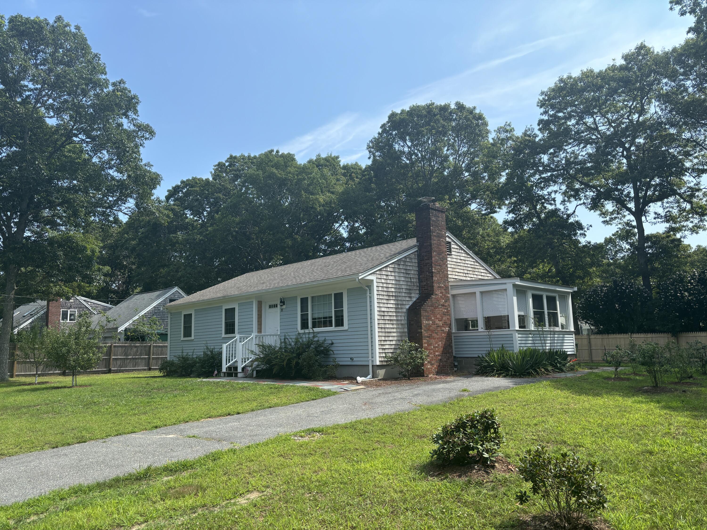 a front view of house with yard and green space