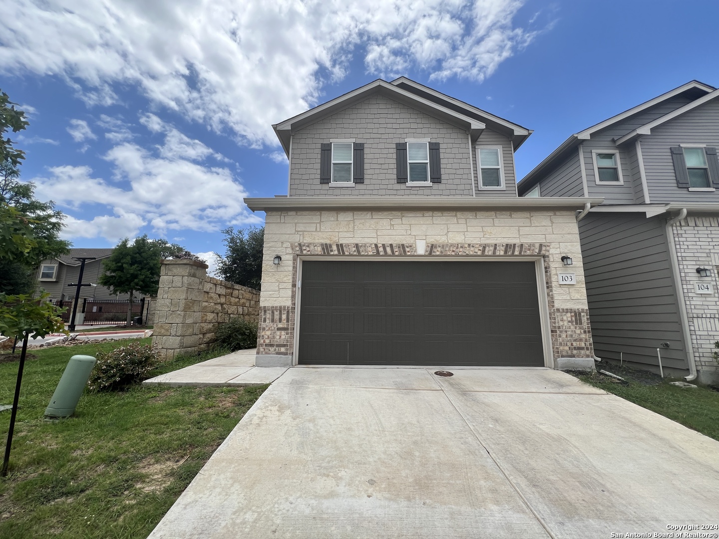 a front view of a house with a yard