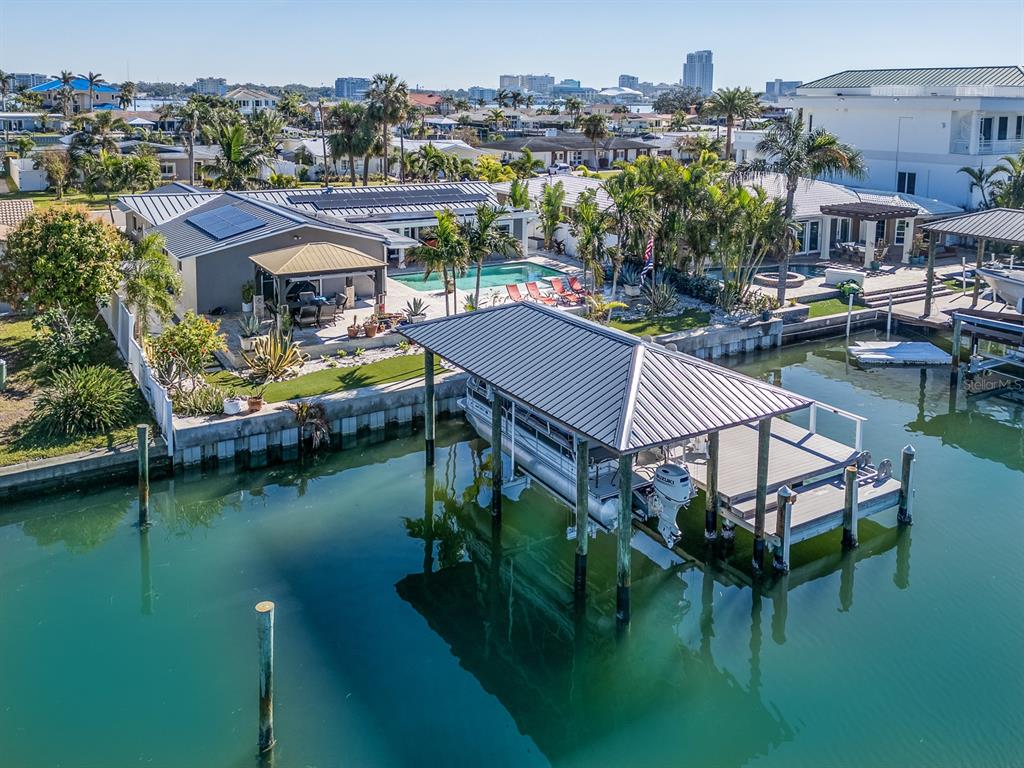 a aerial view of a house with swimming pool and lake view