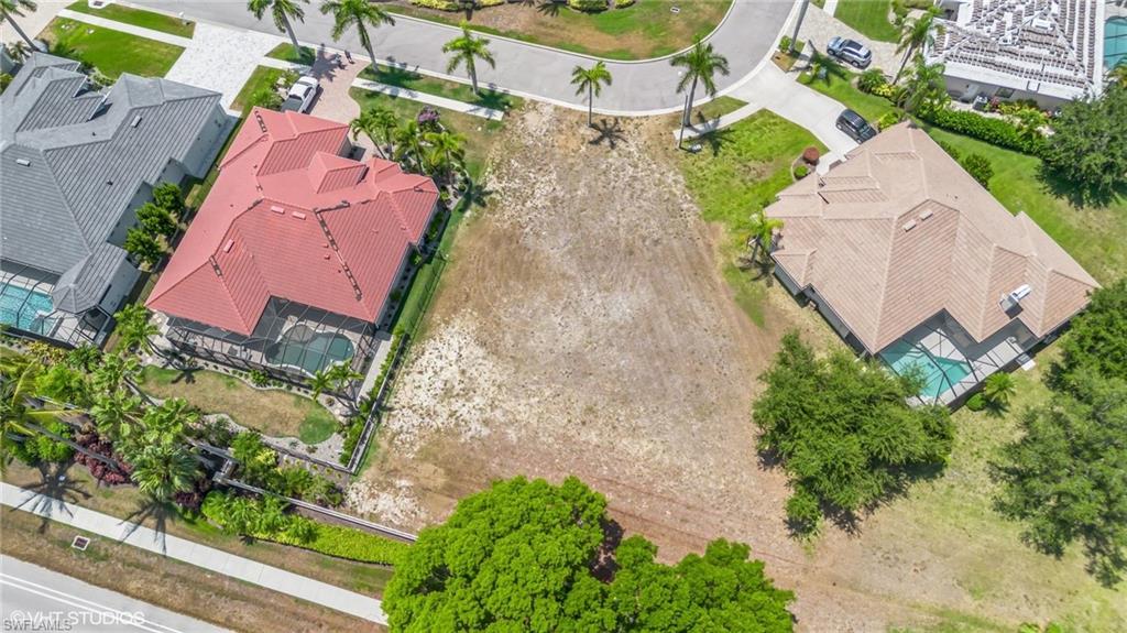 an aerial view of a house with garden space and street view