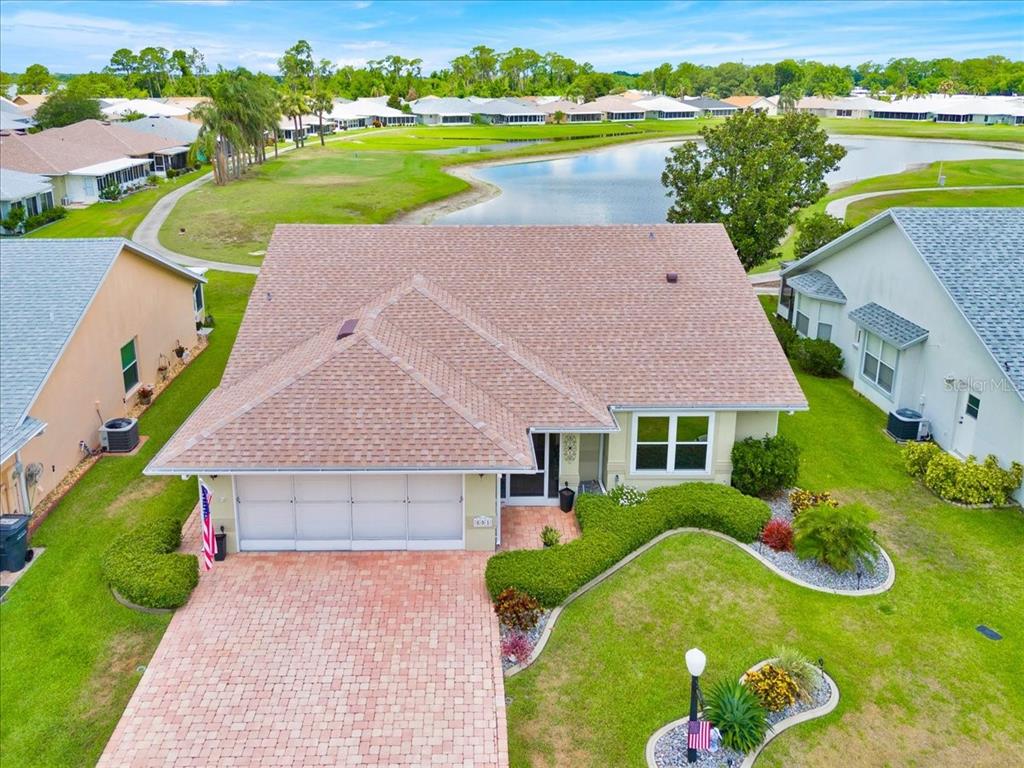 an aerial view of a house with a garden and swimming pool