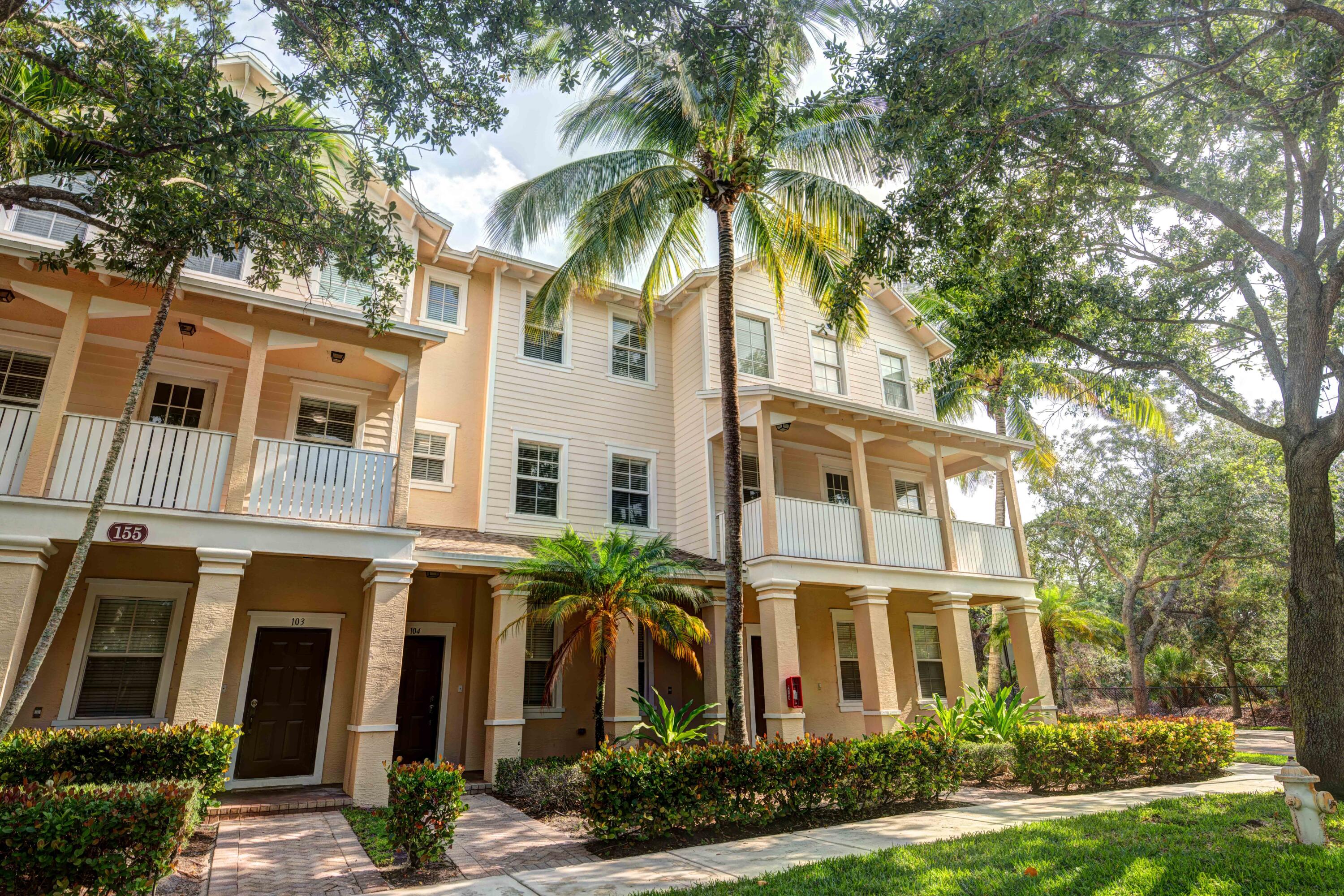 a front view of a residential apartment building with a yard