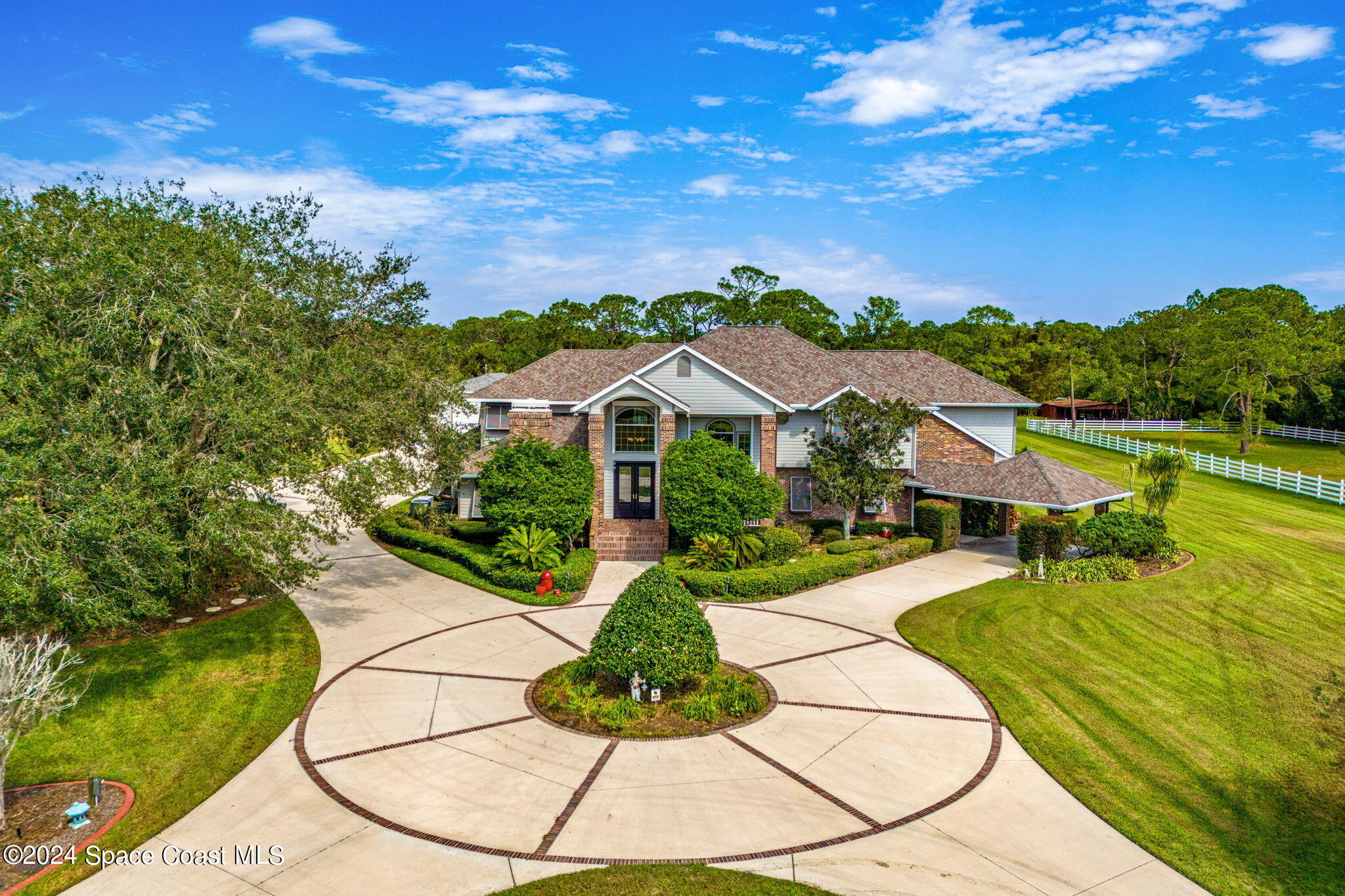 an aerial view of residential houses with outdoor space and street view