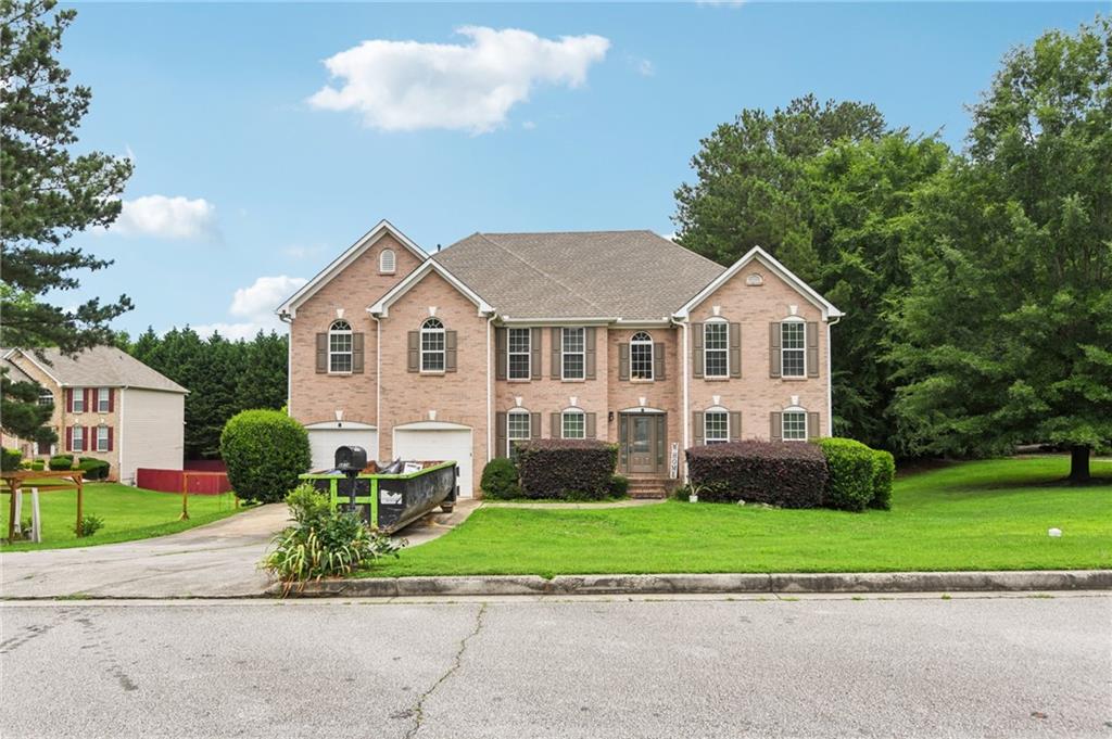 a front view of a house with a yard