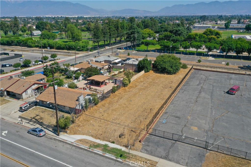 an aerial view of a house with a yard and street view