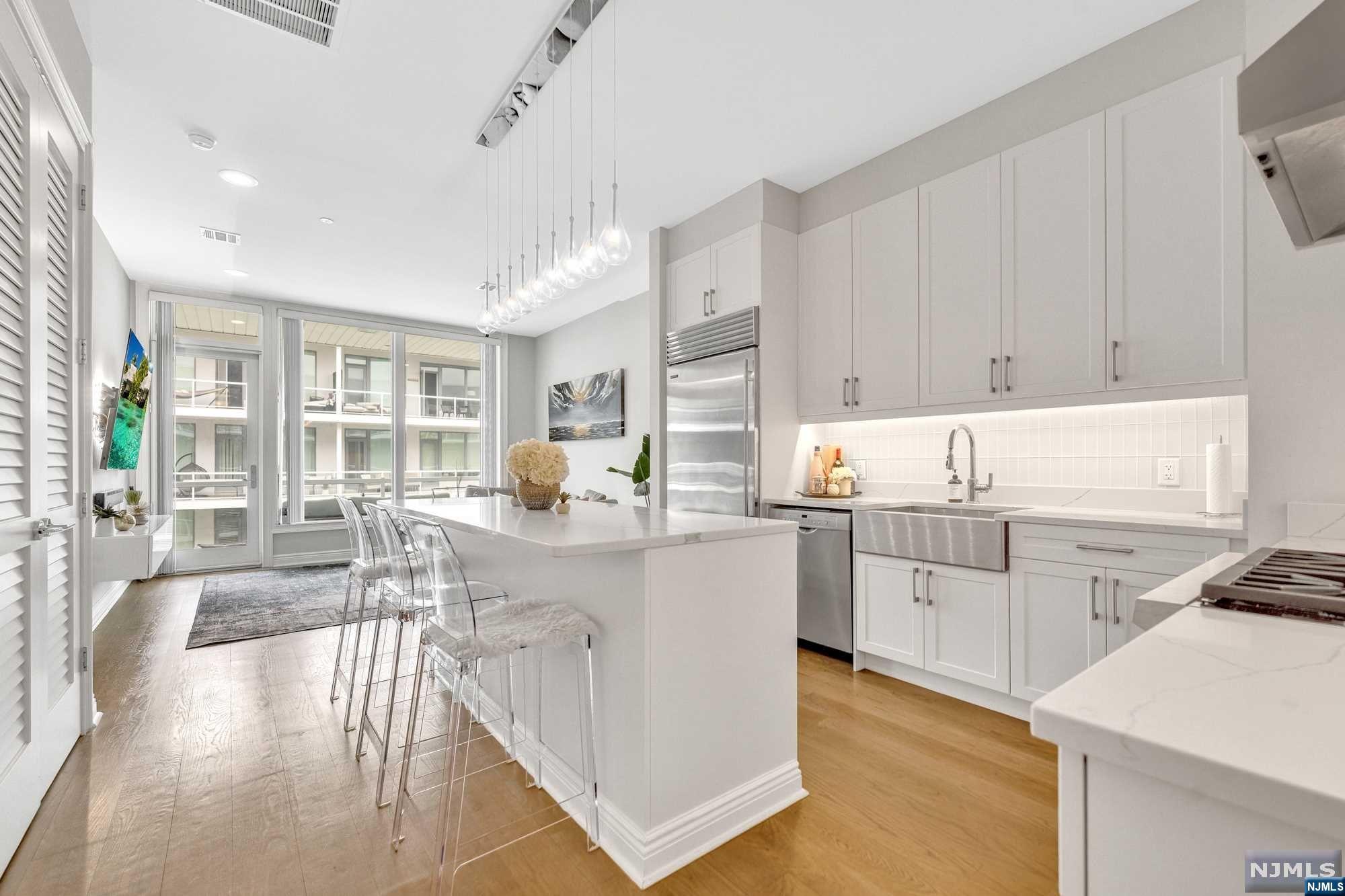 a kitchen with counter top space and wooden floor