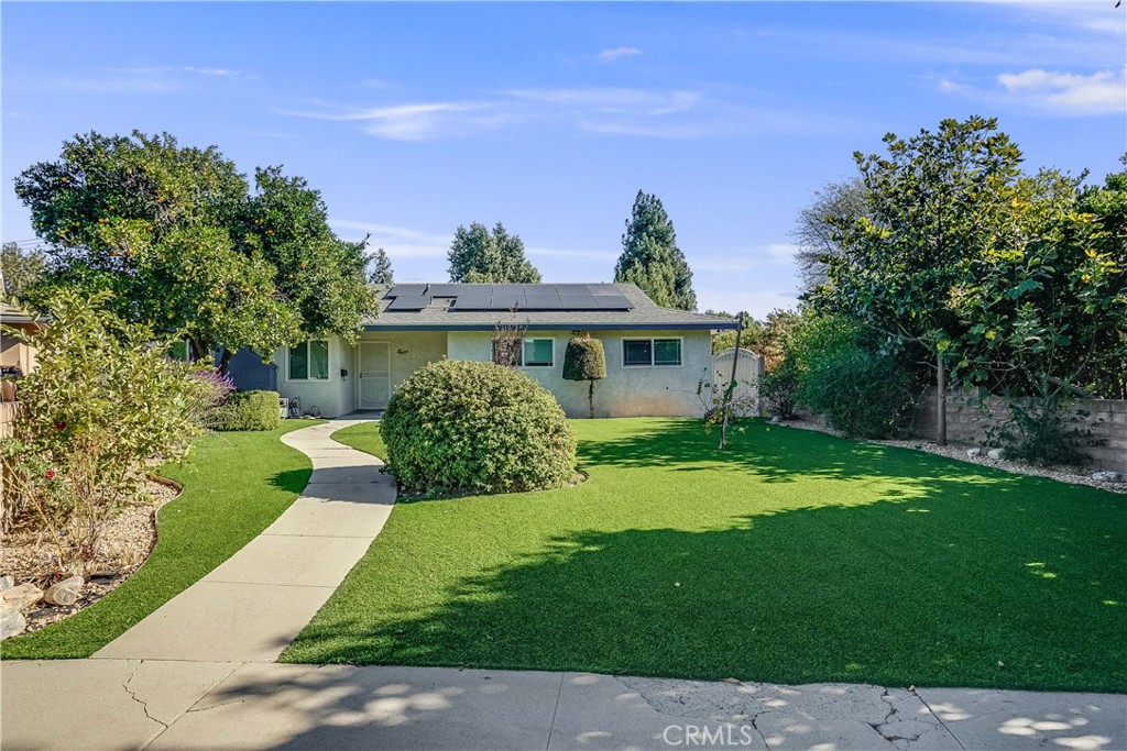 a view of an house with backyard space and garden