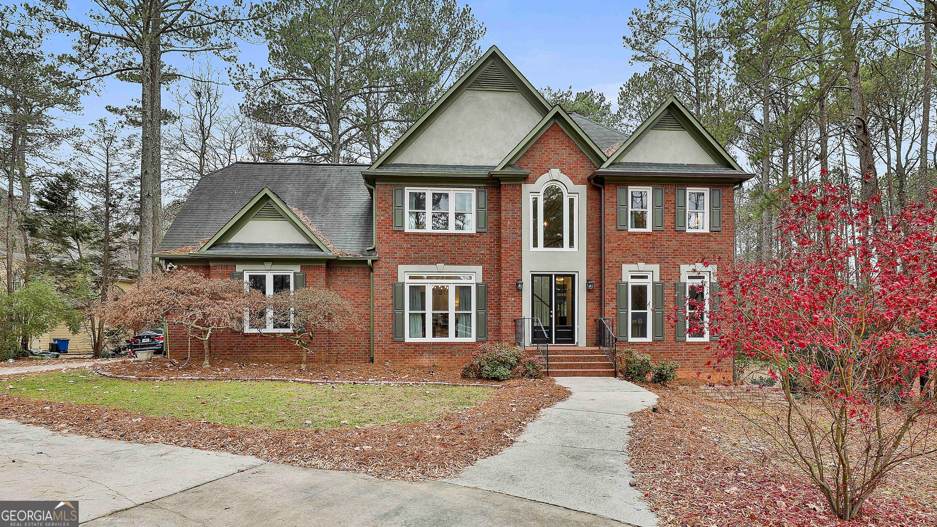 a front view of a house with a yard