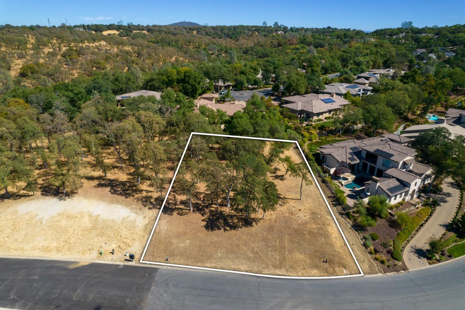 a view of a swimming pool with a yard and mountain view