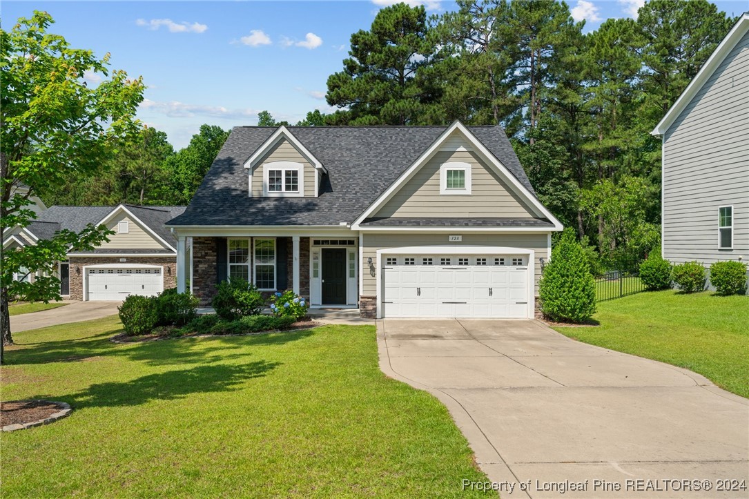 a front view of a house with a yard and garage