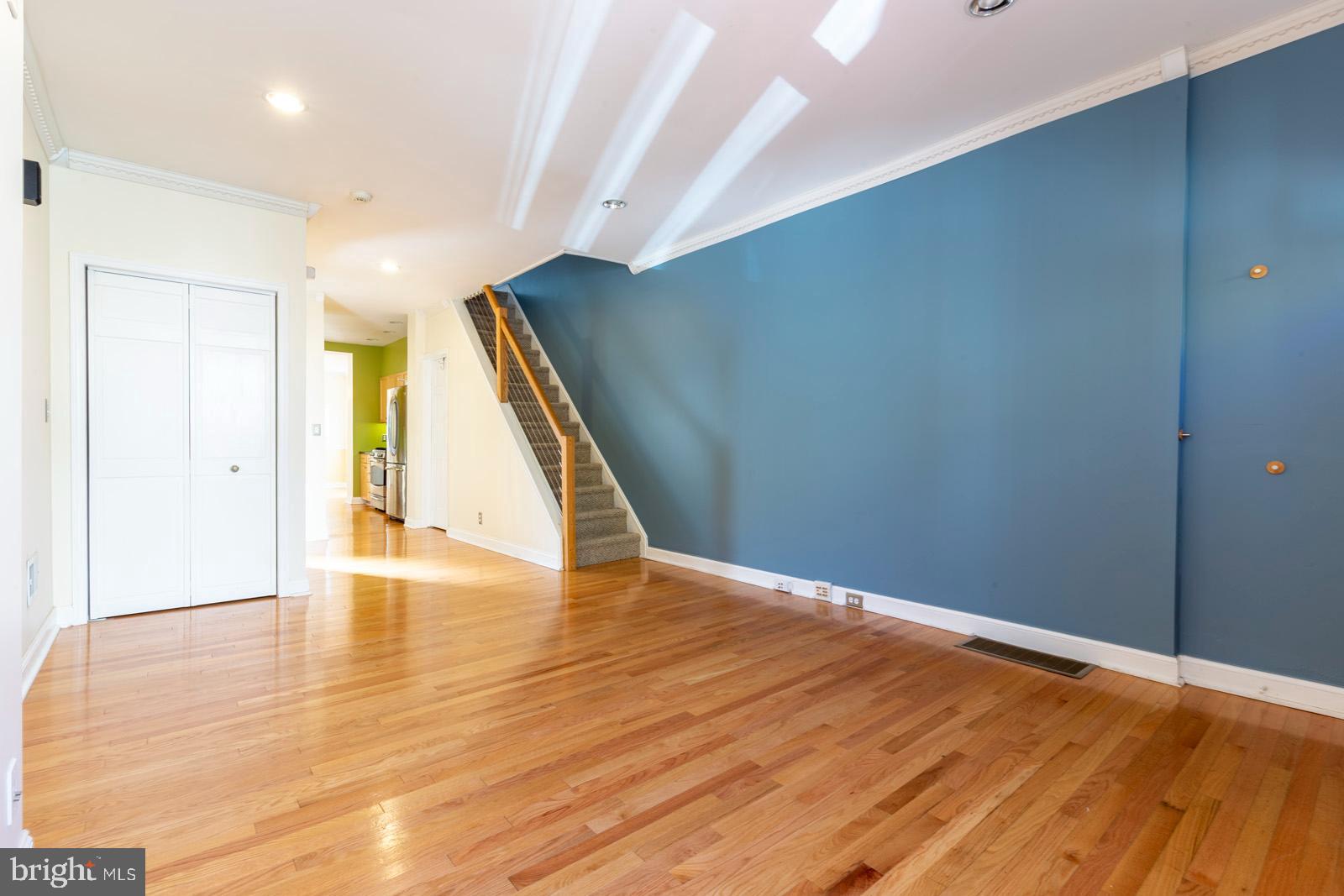 a view of an empty room with wooden floor