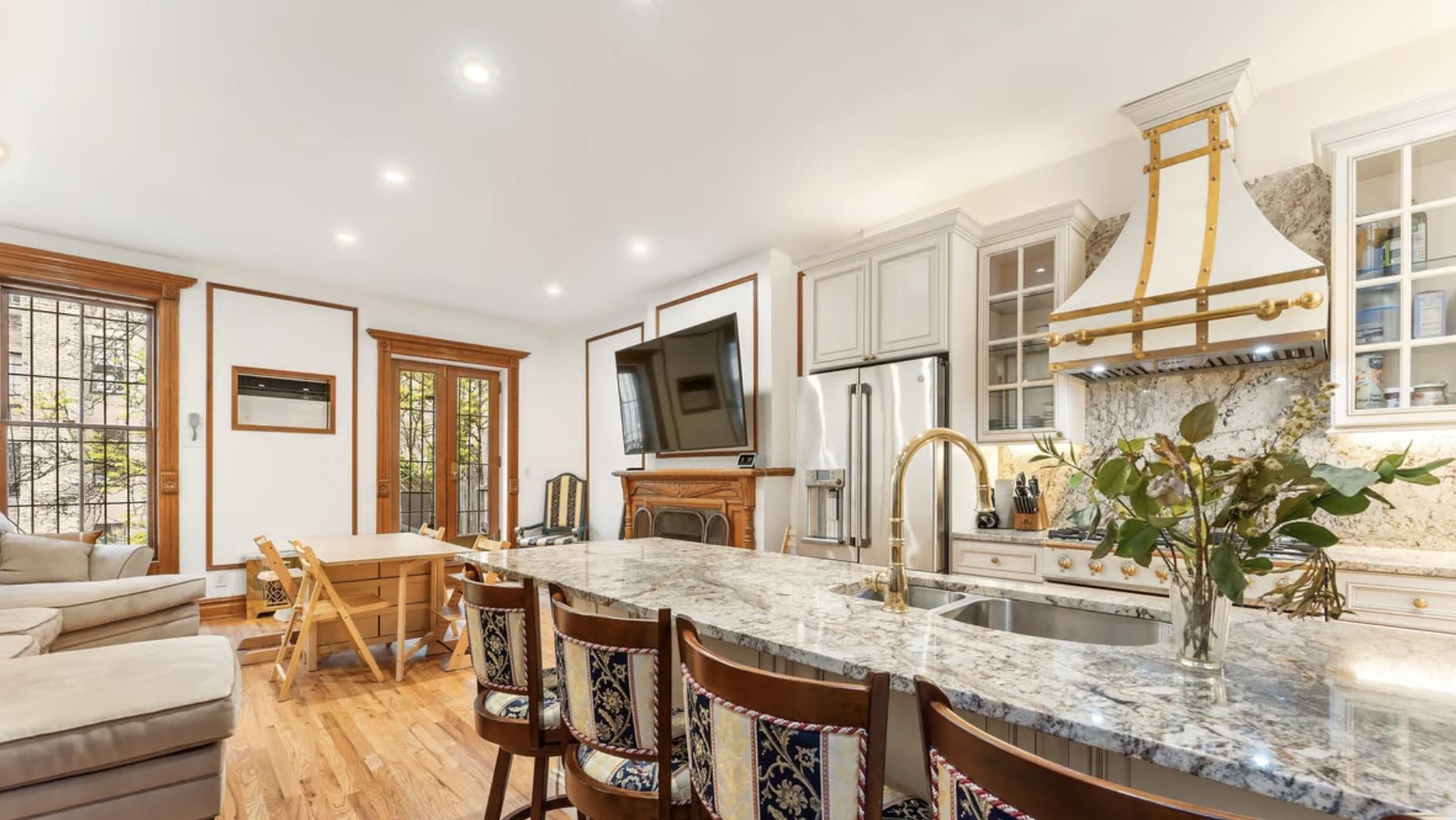 a kitchen with granite countertop a sink and a refrigerator