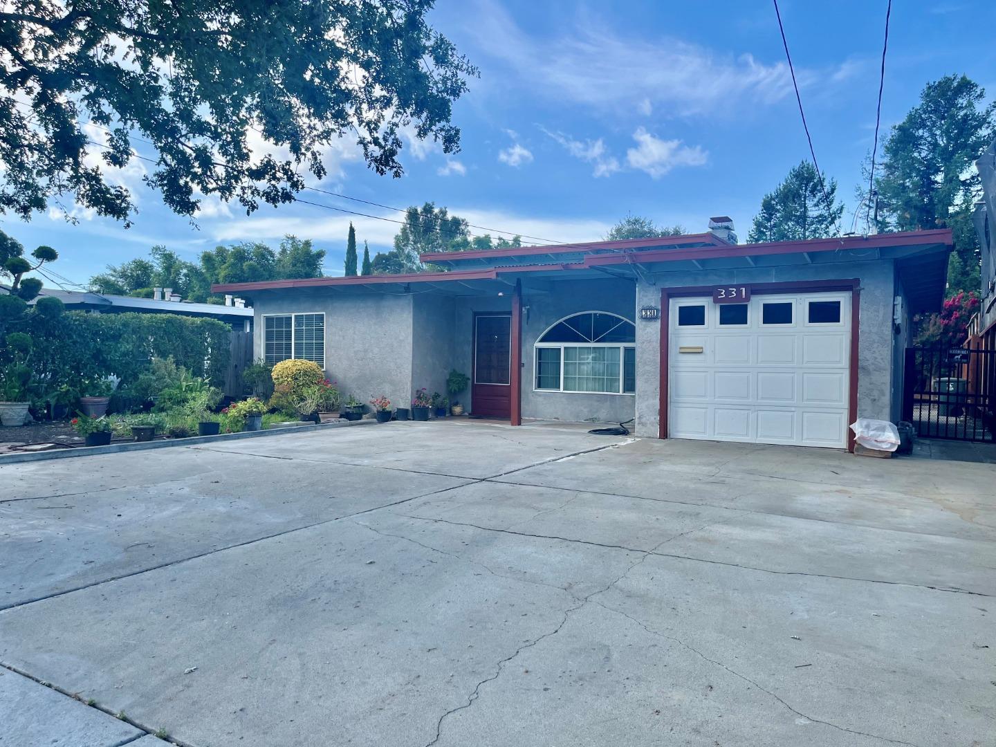 a view of a house with a yard and garage